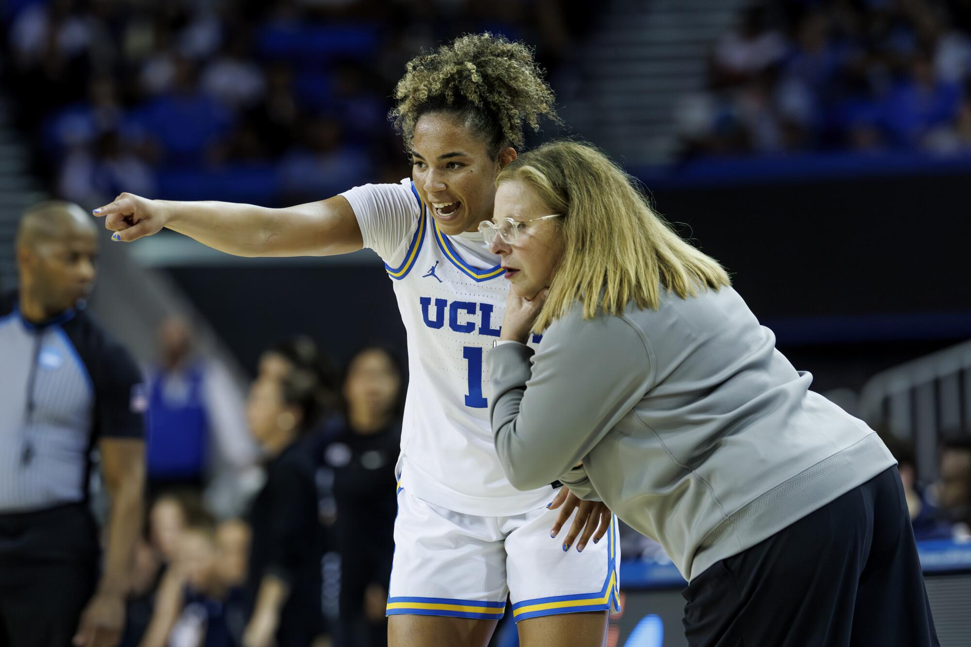 UCLA guard Kiki Rice consults with coach Cori Close on a play against California Baptist at Pauley Pavilion on Saturday.