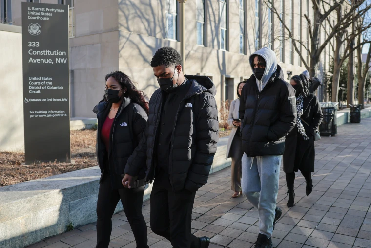Brian Cole Jr.'s family exit the E. Barrett Prettyman Courthouse