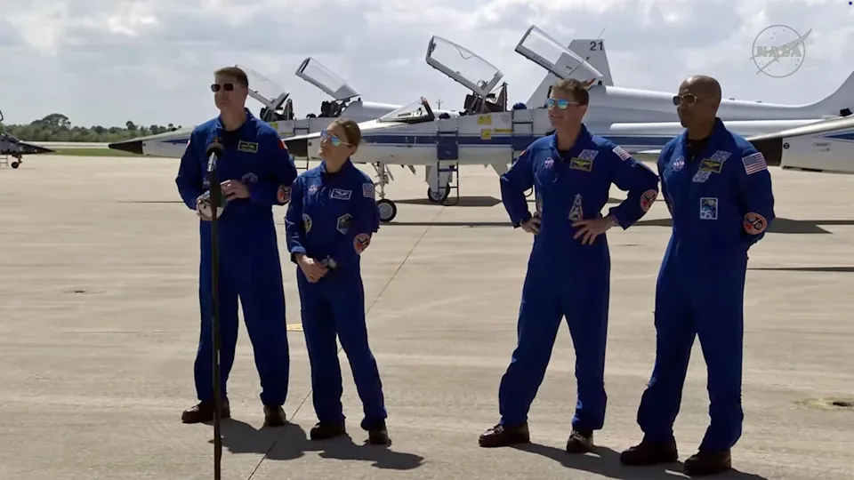 The Artemis II crew, fielding questions from reporters at the Kennedy Space Center runway on March 27, 2026, after arriving to make final preparations for launch. Left to right: Canadian astronaut Jeremy Hansen, NASA astronaut Christina Koch, mission commander Reid Wiseman and pilot Victor Glover. Koch, Wiseman and Glover are NASA space veterans while Hansen will be making his first flight. / Credit: NASA