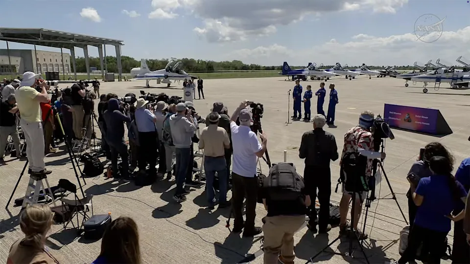 A larger-than-usual crowd of reporters and photographers greeted the Artemis II crew on the Kennedy Space Center runway, indicating broad interest in NASA's first moonshot in more than 50 years. / Credit: NASA
