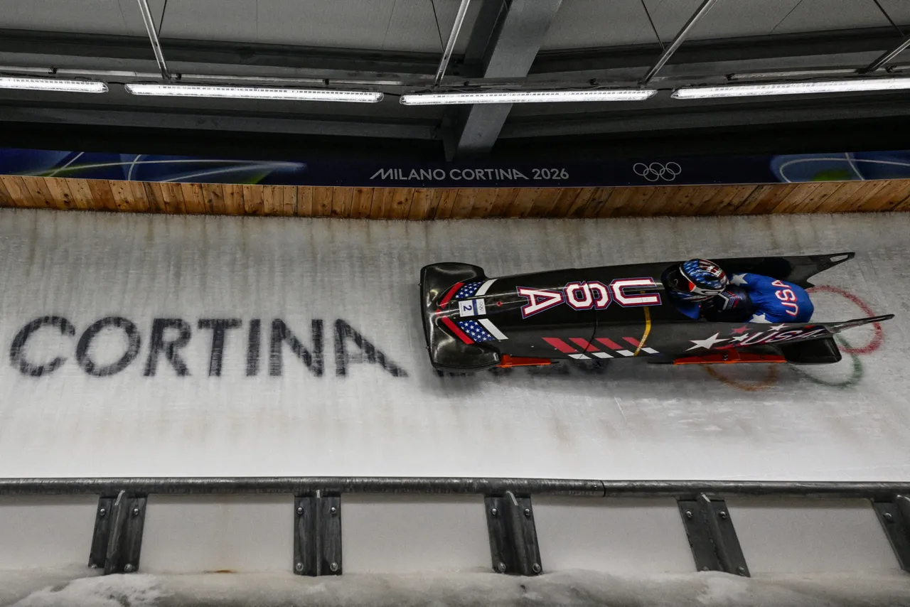 USA's Kaillie Armbruster Humphries and USA's Jasmine Jones compete in the bobsleigh women's 2-woman heat 3 at Cortina Sliding Centre during the Milano Cortina 2026 Winter Olympic Games in Cortina d'Ampezzo on February 21, 2026. (Photo by Tiziana FABI / AFP via Getty Images)