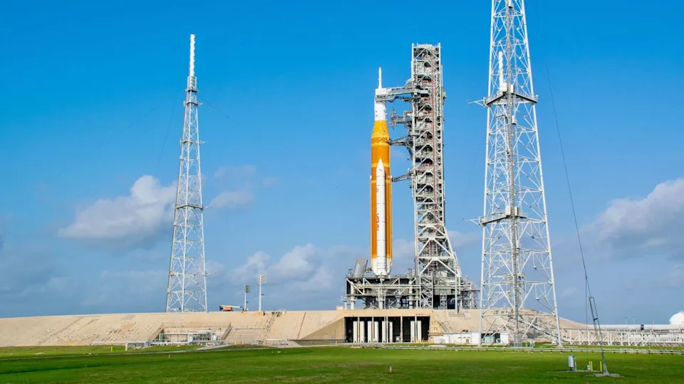  An orange rocket on the launchpad. 