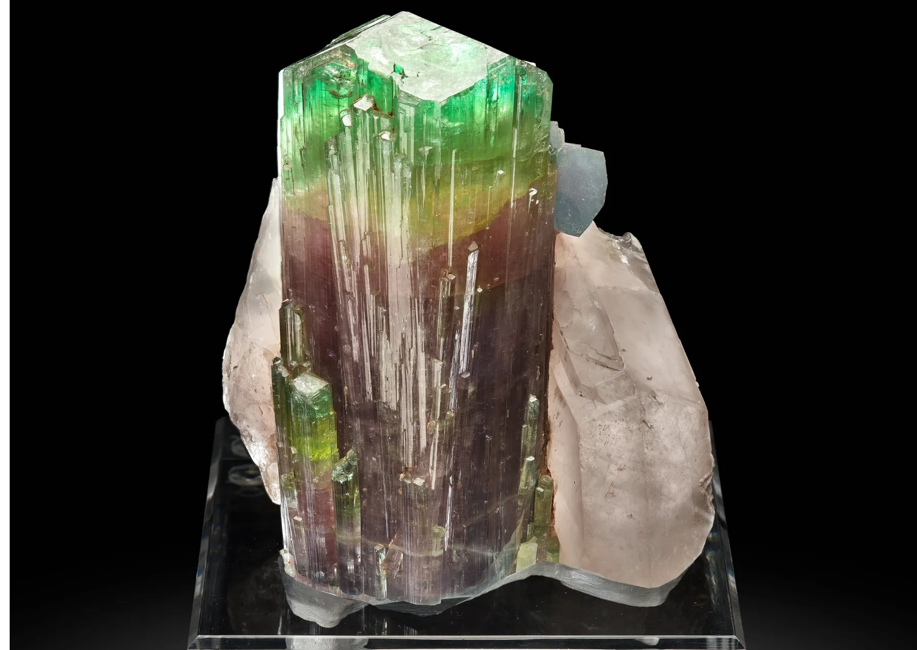 a large rectangular mineral with a green, yellow, and red layer