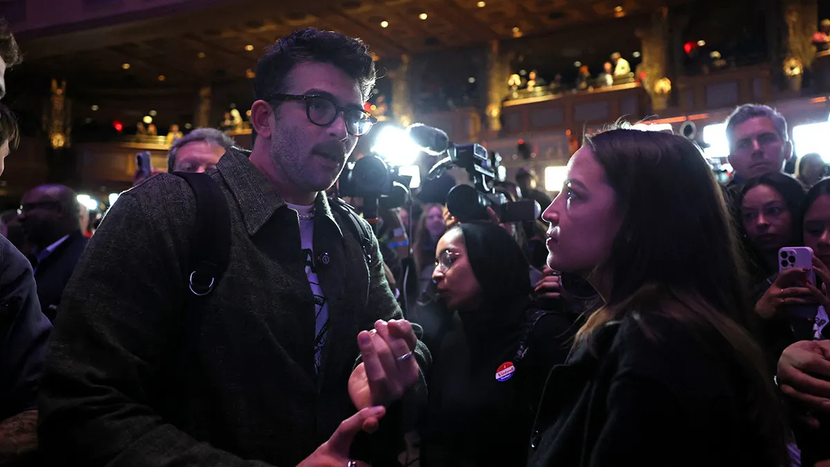 US Representative Alexandria Ocasio-Cortez (R) chats with supporters of New York City Mayoral candidate Zohran Mamdani
