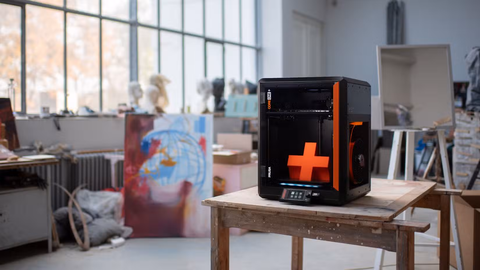 Prusa CORE One+ in an art studio setting.