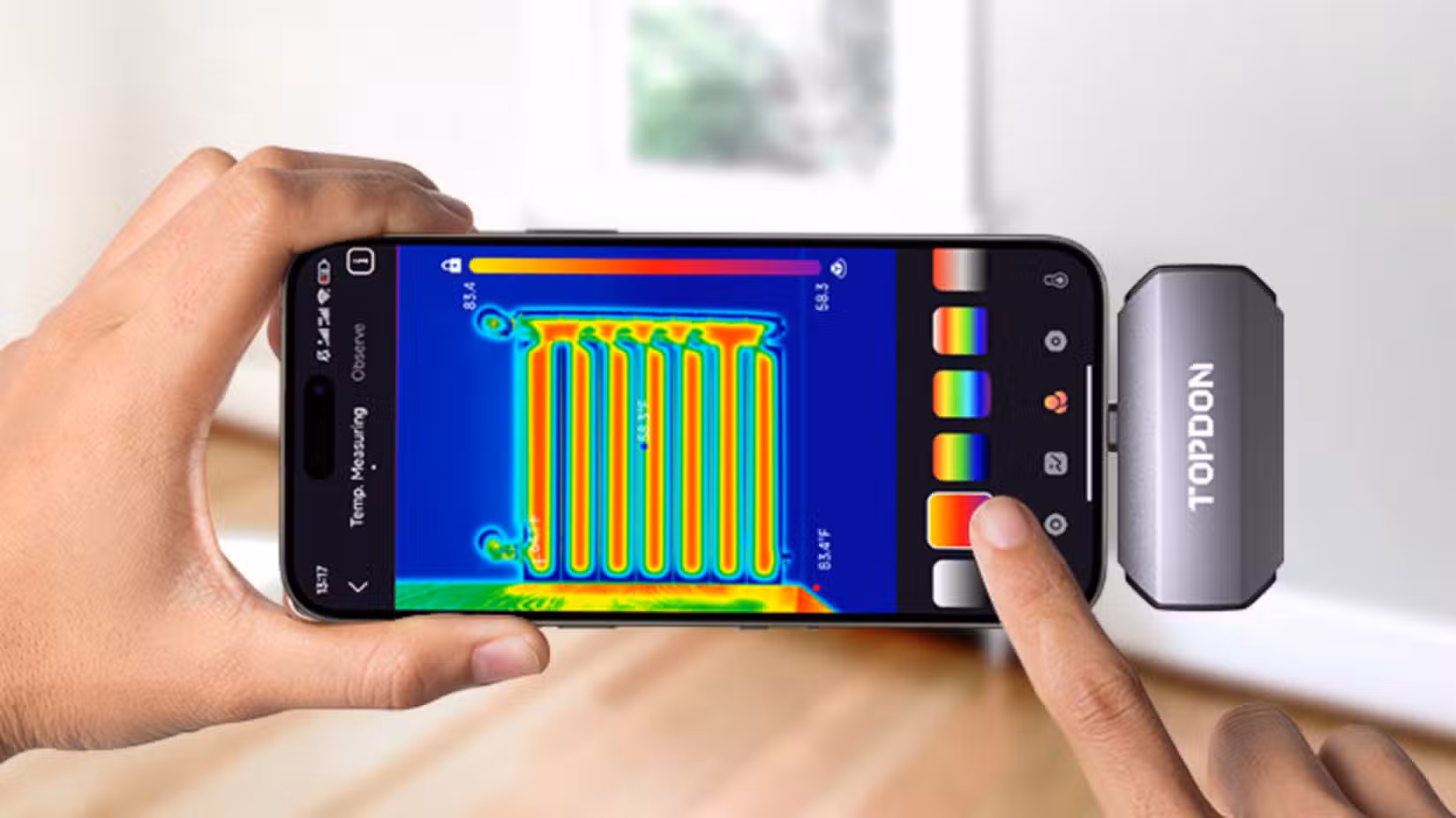 Thermal image camera plugged into a phone USB port. 