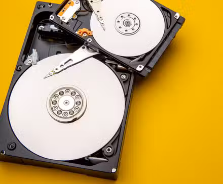 Mechanical hard drives with the covers removed and disks exposed.