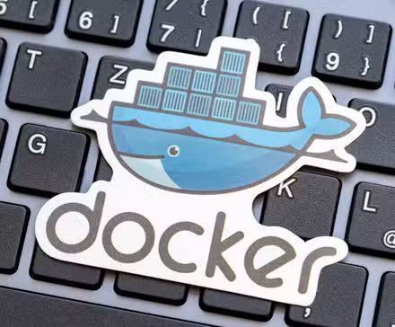  Docker logo placed over a laptop computer keyboard.
