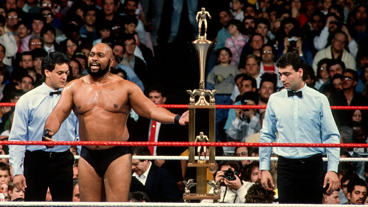 Bad News Brown holds a trophy