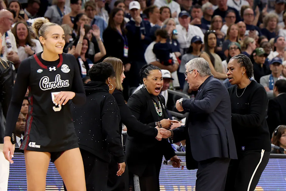 PHOENIX, ARIZONA - APRIL 03: Head coach Dawn Staley of the South Carolina Gamecocks and head coach Geno Auriemma of the UConn Huskies exchange words during the fourth quarter in the Final Four of the NCAA Women's Basketball Tournament at Mortgage Matchup Center on April 03, 2026 in Phoenix, Arizona. (Photo by Christian Petersen/Getty Images)