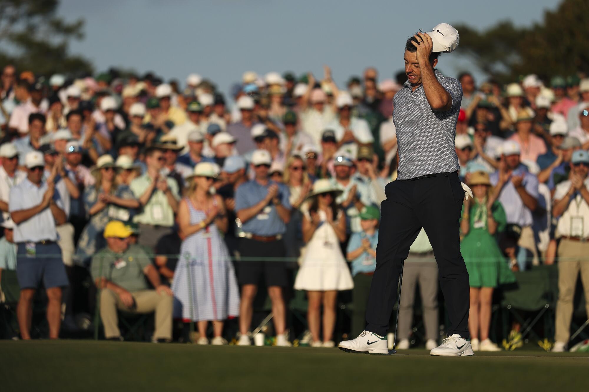 Rory McIlroy reacts in frustration on the 18th green during the third round of the Masters on Sunday in Augusta, Ga.