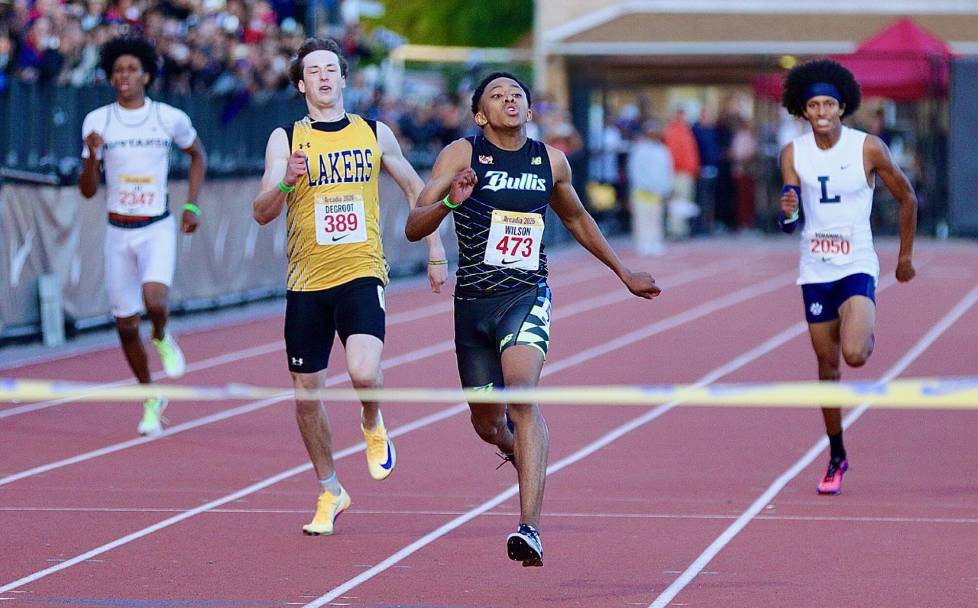 Olympian Quincy Wilson (center) cruises to victory in the 400-meter dash in a meet record 45.48 seconds.