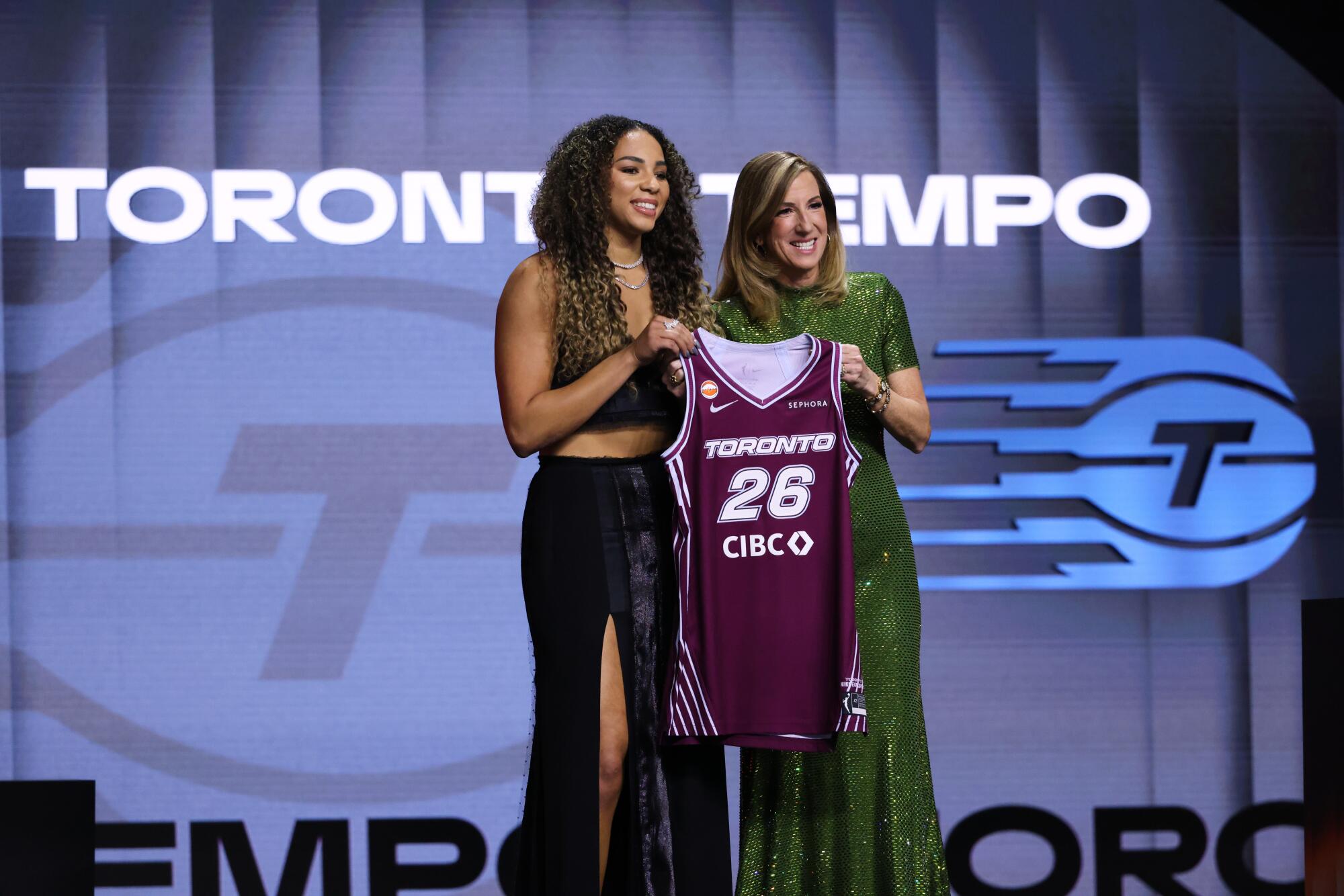 UCLA guard Kiki Rice poses with WNBA commissioner Cathy Engelbert after being selected No. 6 by the Toronto Tempo.