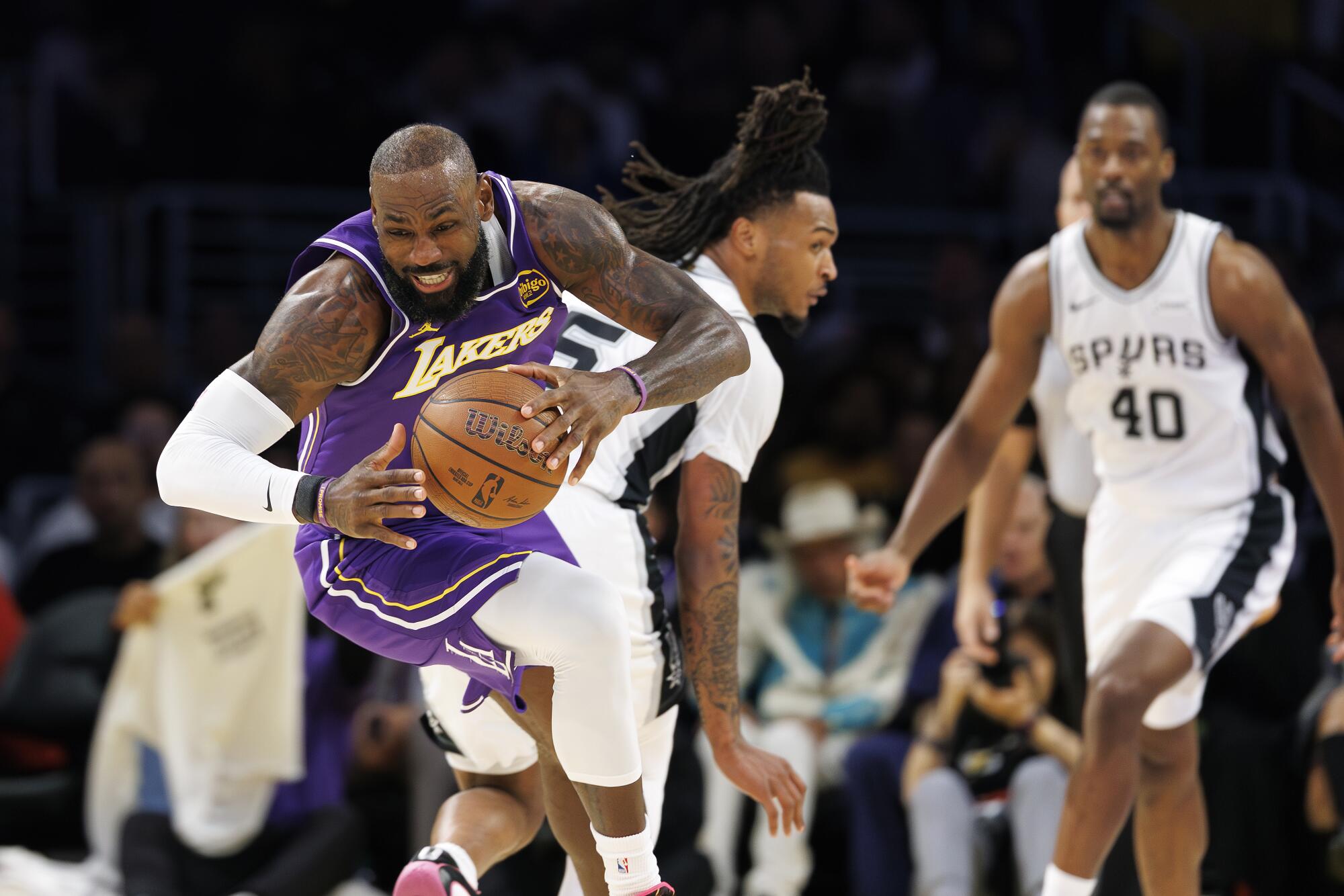 Lakers forward LeBron James starts a fast break against the Spurs.