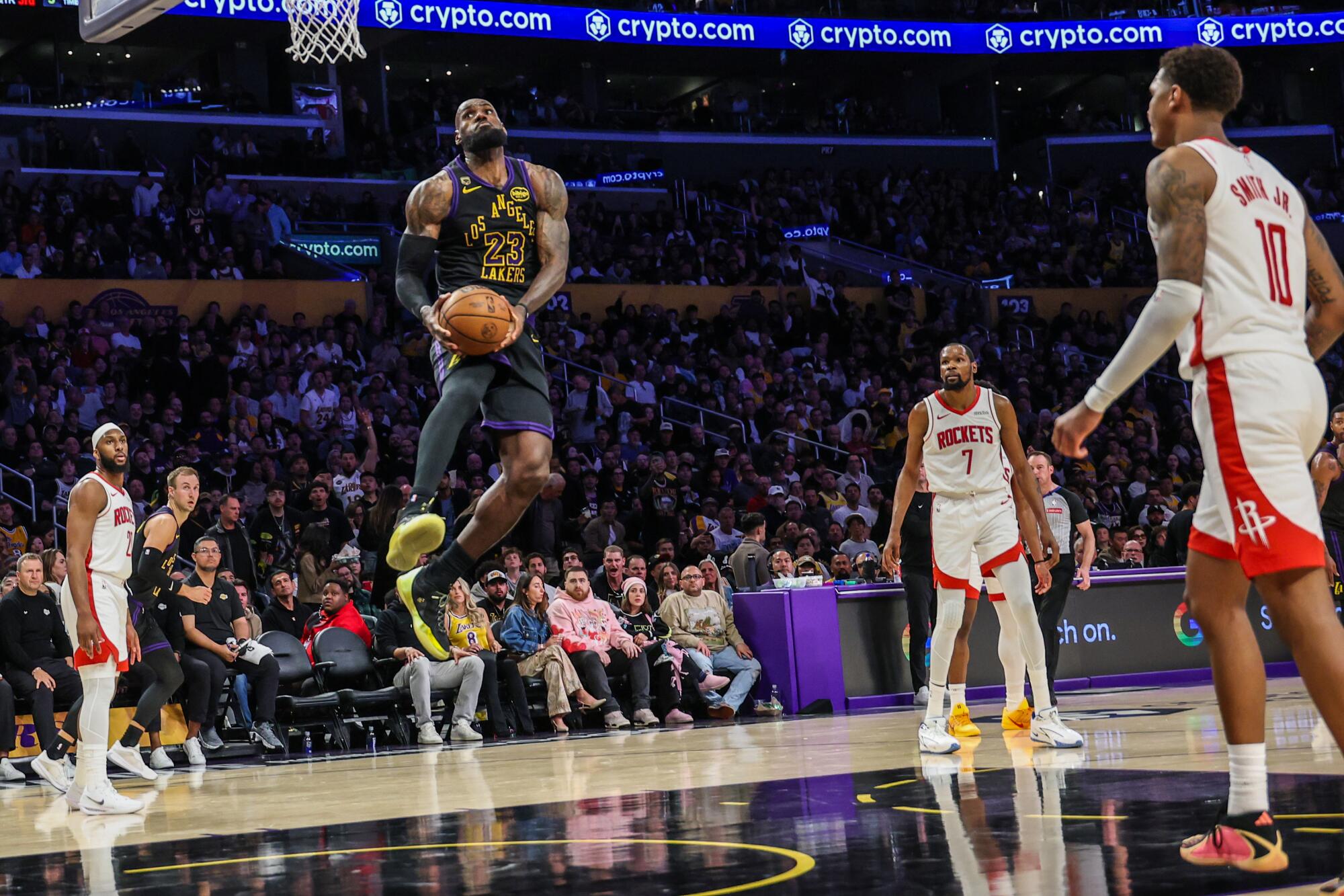 Lakers forward LeBron James leaps up for a reverse slam against the Houston Rockets during Game 2.