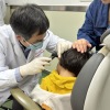 Dr. Yilai Shu examines a young patient at the Eye & ENT Hospital of Fudan University in China.
