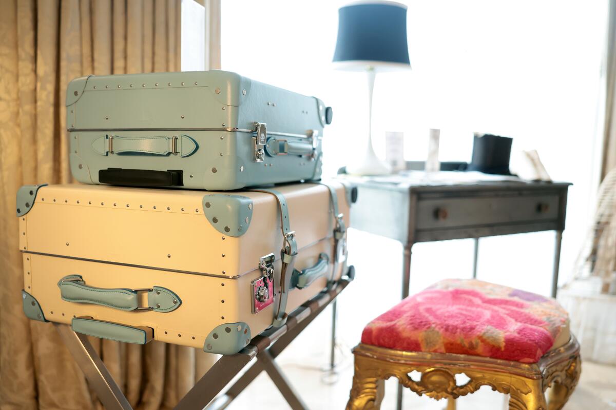 Carrie Bradshaw's globetrotter luggage set, a vintage stool and steel writing desk.