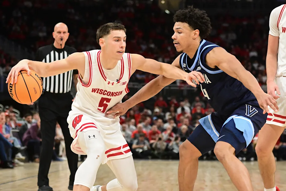 Dec 19, 2025; Milwaukee, Wisconsin, USA; Wisconsin Badgers guard Jack Janicki (5) drives for the basket against Villanova Wildcats guard Tyler Perkins (4) first half at the Fiserv Forum. Mandatory Credit: Benny Sieu-Imagn Images
