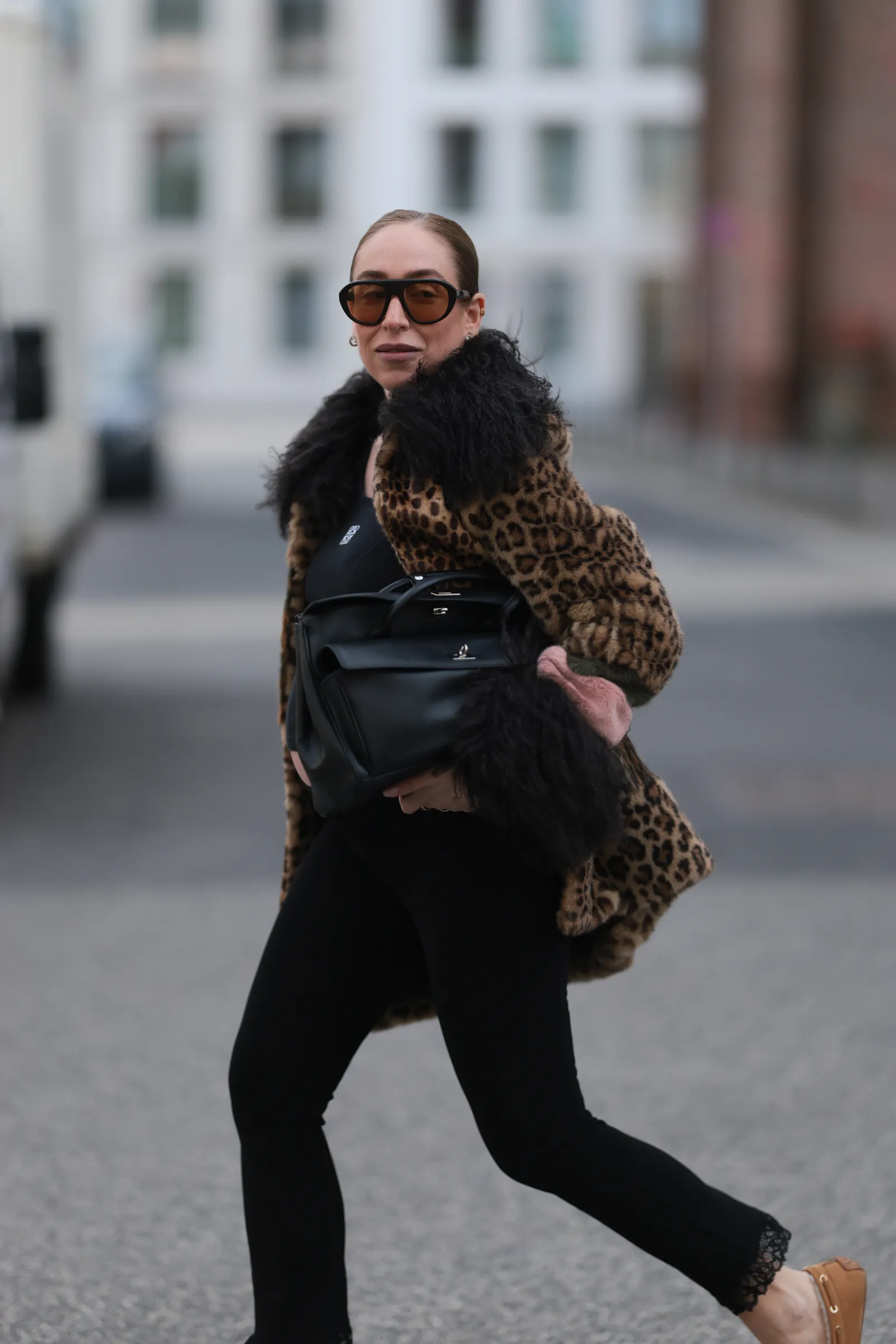 Image may contain Accessories Bag Handbag Clothing Coat Purse Pedestrian Person Adult City Road Street and Urban