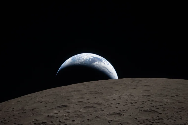 Earth dips beyond the lunar horizon in this irst photo from the far side of the Moon captured from Orion on Monday, April 6, 2026.
