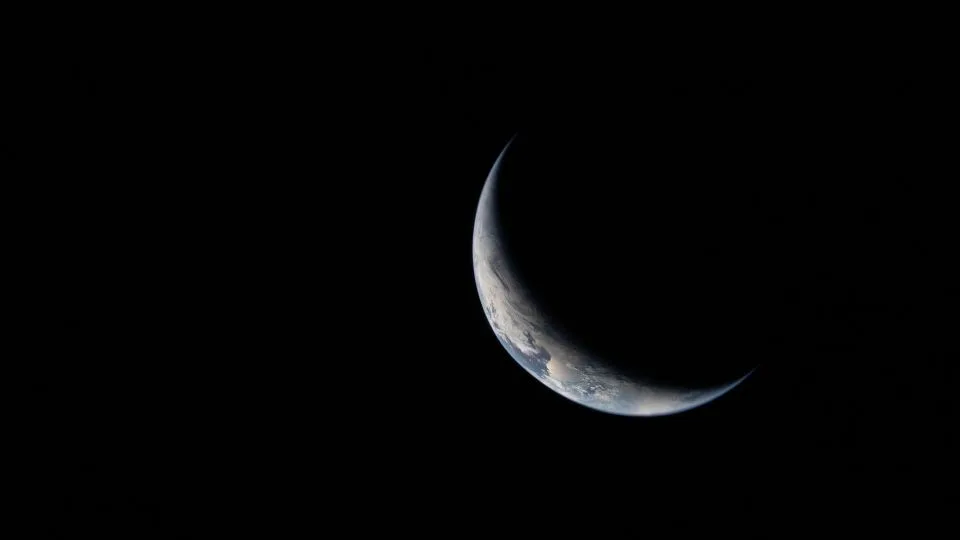 Earth appears as a crescent on the third day of the mission. - NASA