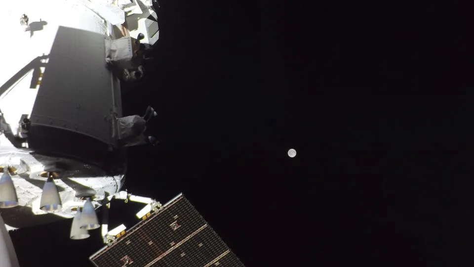 A camera on Orion's solar array wings shows the moon in the distance on the mission's second day. - NASA