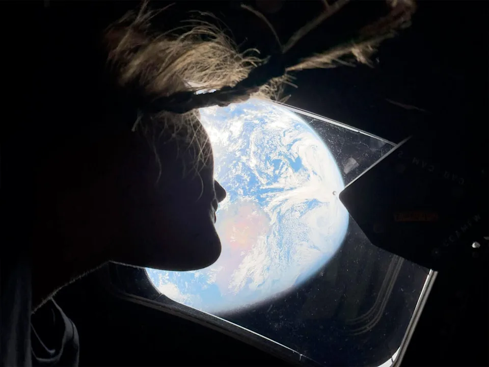Astronaut Christina Koch takes in a view of planet Earth as the Artemis II crew headed for deep space and a flight around the far side of the moon Monday. / Credit: NASA