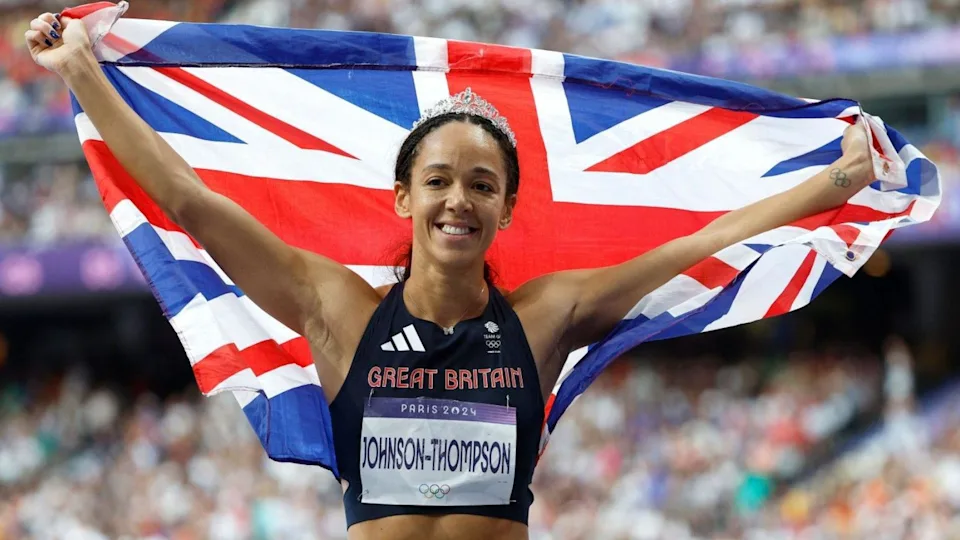 Katarina Johnson-Thompson celebrating while holding a Union Flag at the Paris 2024 Olympic Games