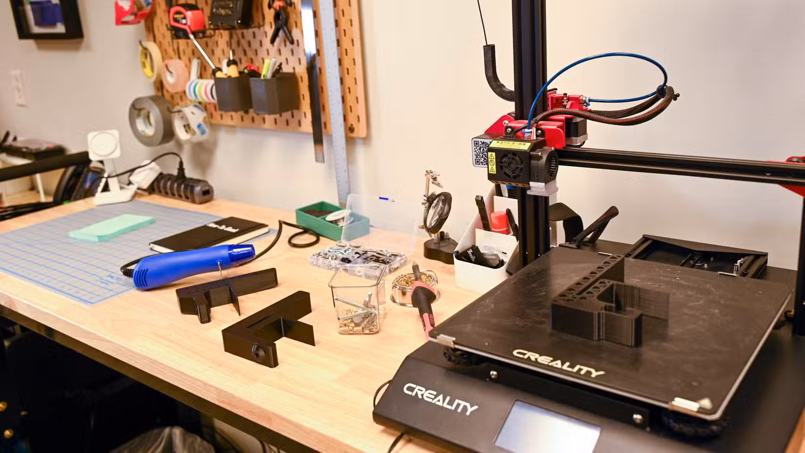 3D Printer on a workbench with soldering materials.