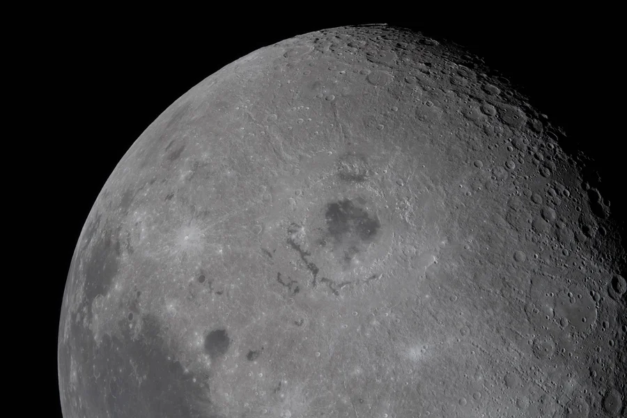 A close-up of the moon, visualizing some of its craters.