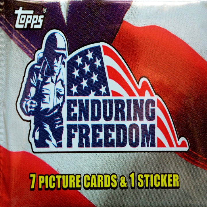 A pack of Topps cards featuring the "Enduring Freedom" logo with an American flag and soldier graphic, containing 7 picture cards and 1 sticker