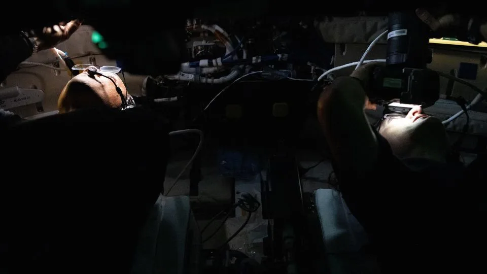 NASA astronauts Victor Glover and Christina Koch capture lunar images through Orion's windows. - NASA