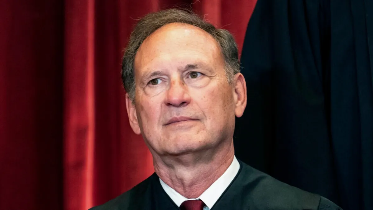 Supreme Court Justice Samuel Alito standing and speaking.