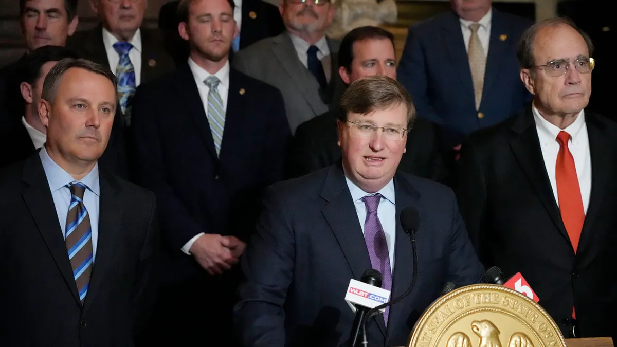 Mississippi Gov. Tate Reeves speaking at the Mississippi Capitol in Jackson with Lt. Gov. Delbert Hosemann and Jason White