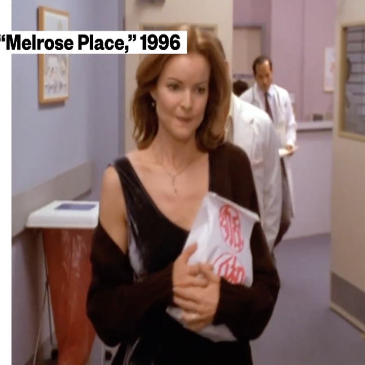 Woman holding a package in a hospital hallway from a scene in "Melrose Place," 1996