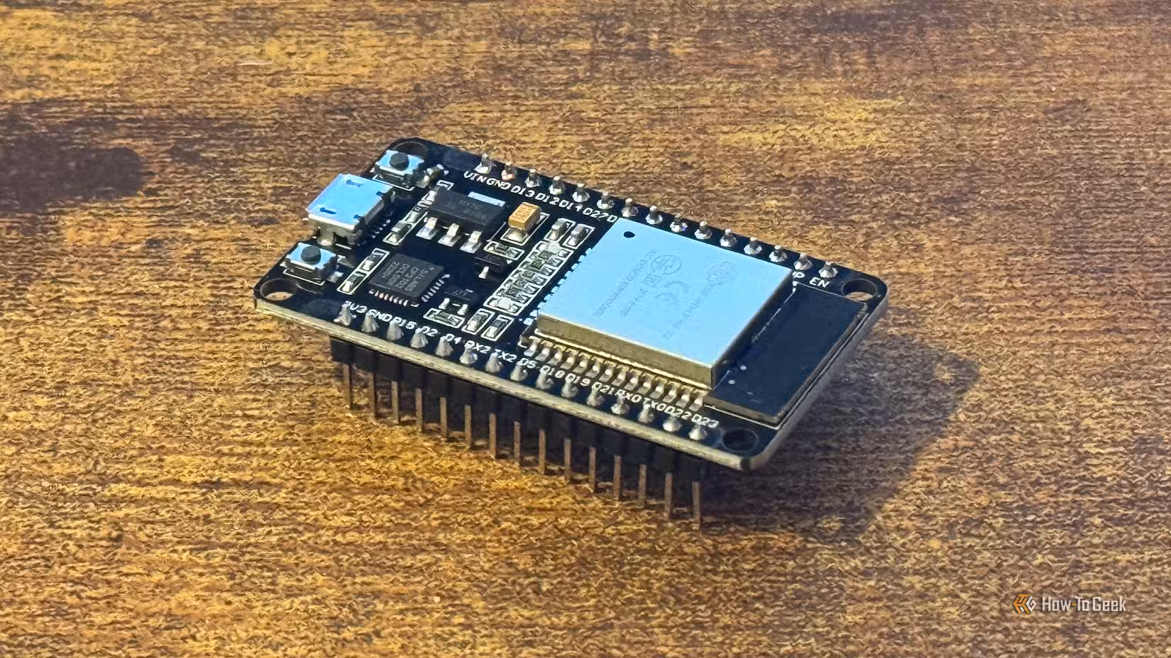 An ESP32 microcontroller on a desk.