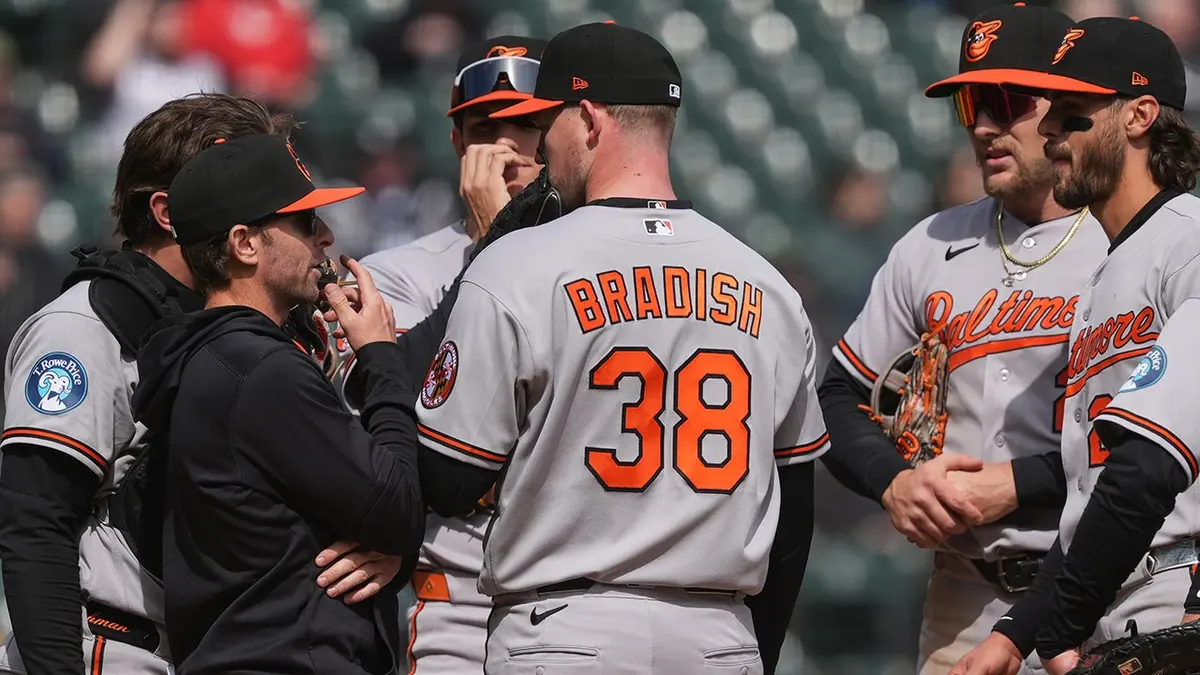 Baltimore Orioles manager Craig Albernaz talking with pitcher Kyle Bradish on the field