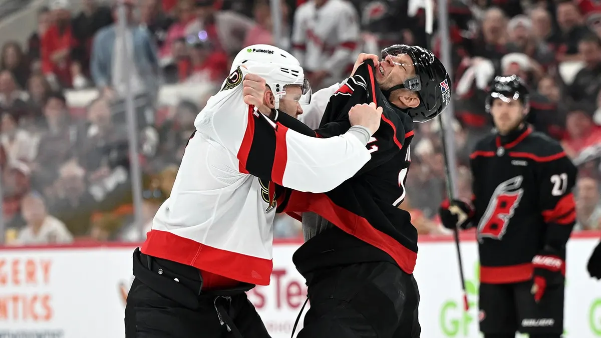Brady Tkachuk and Jordan Staal fighting during NHL Stanley Cup Playoffs game.