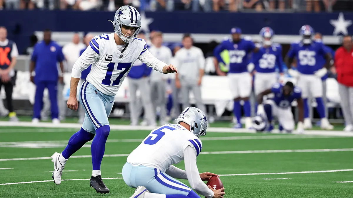 Brandon Aubrey kicking a field goal during a football game at AT&T Stadium