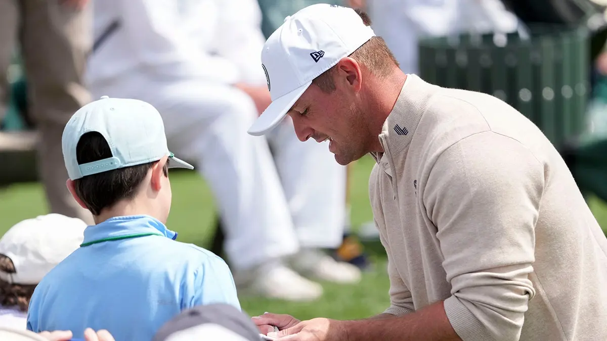 Bryson DeChambeau signing autographs at the Masters Tournament Par 3 Contest