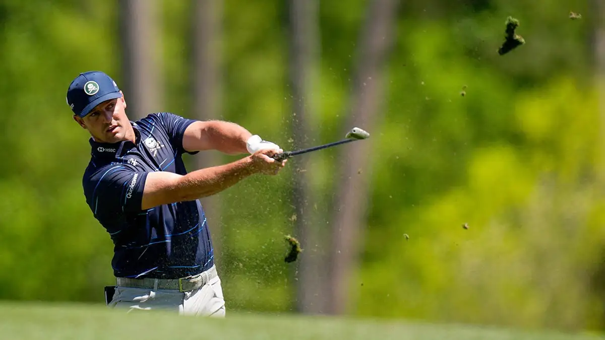 Bryson DeChambeau hitting a tee shot on the 12th hole at Augusta National Golf Club