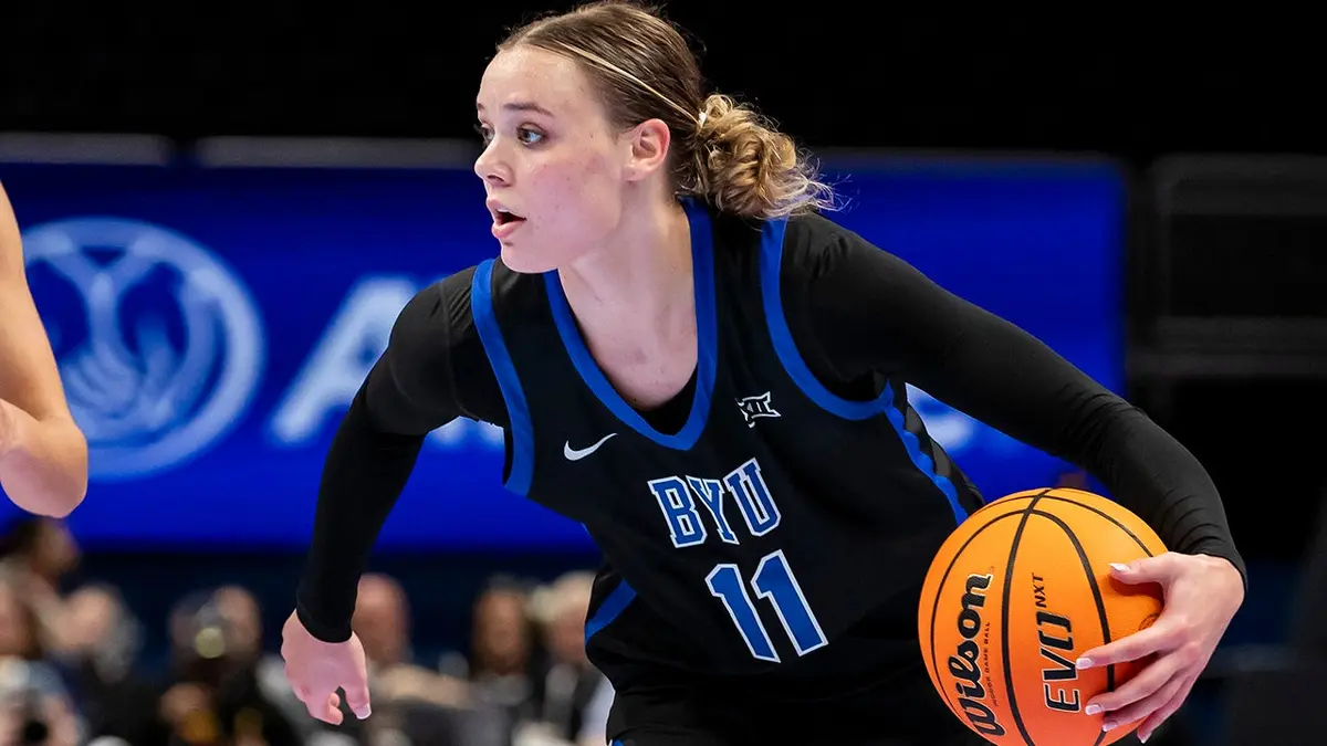 BYU guard Delaney Gibb driving basketball against TCU Horned Frogs at T-Mobile Center