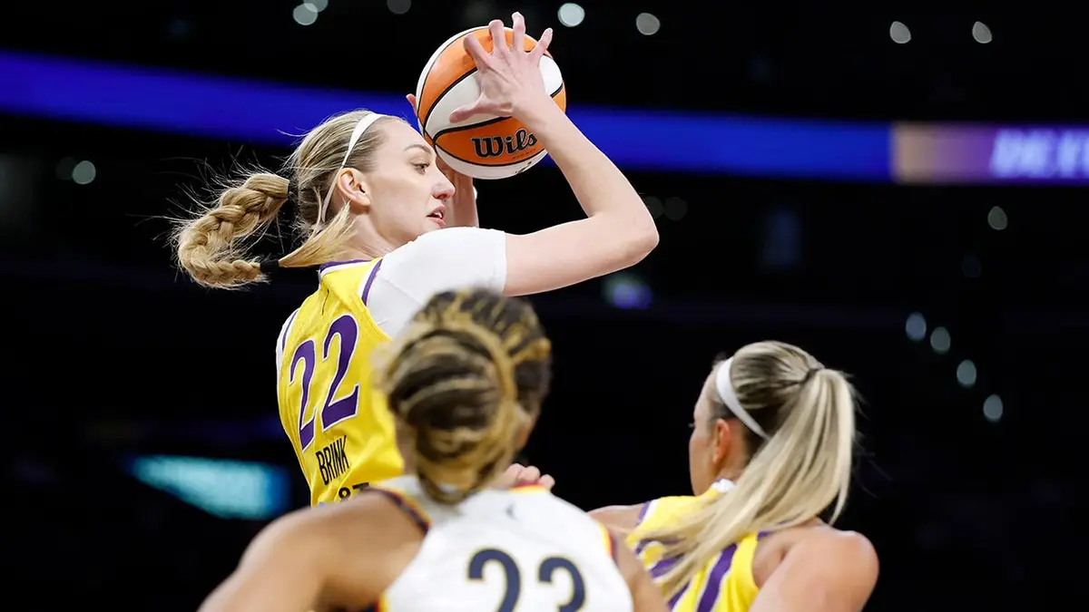 Cameron Brink of the Los Angeles Sparks controls a rebound over Aerial Powers and Julie Allemand during a basketball game.