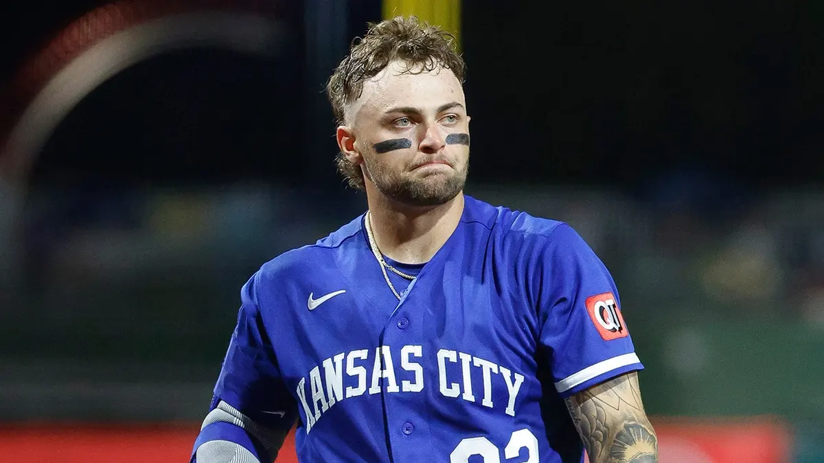 Carter Jensen walking to the on deck circle during a baseball game.