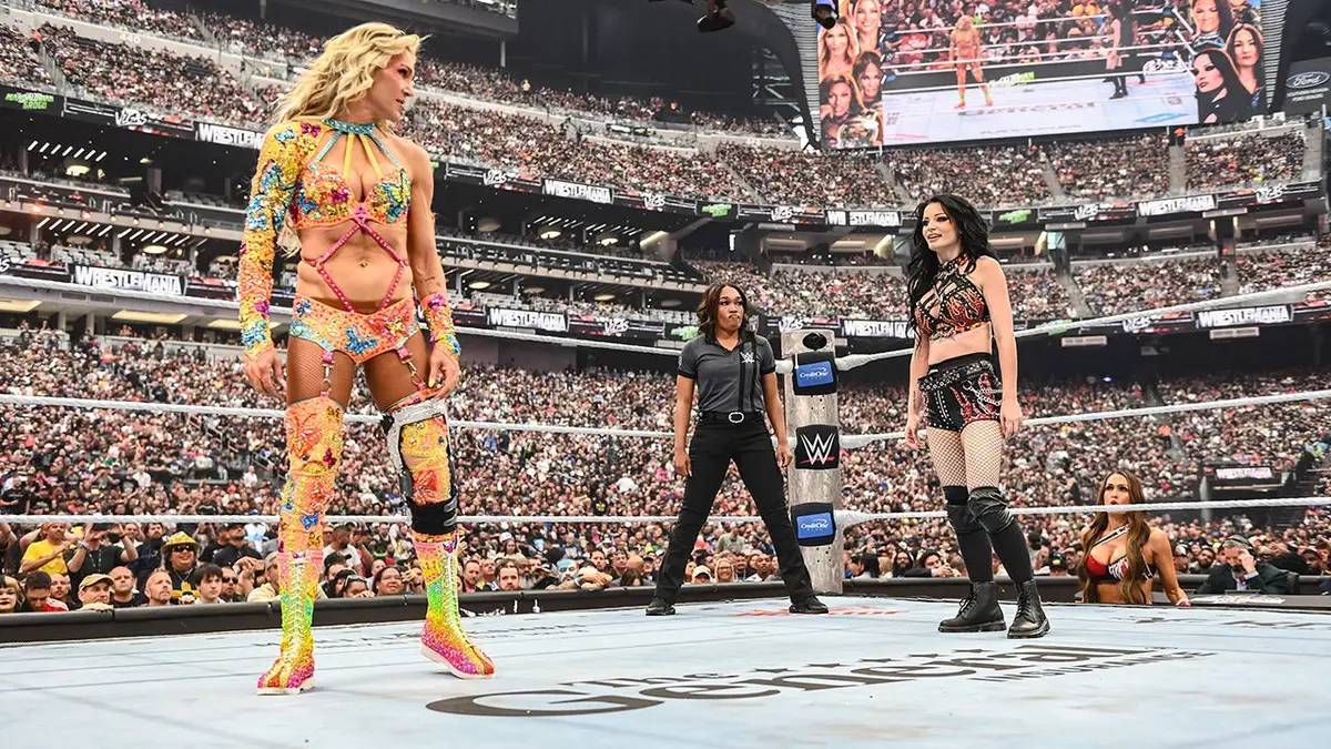 Charlotte Flair faces off with Paige in a wrestling ring at Allegiant Stadium