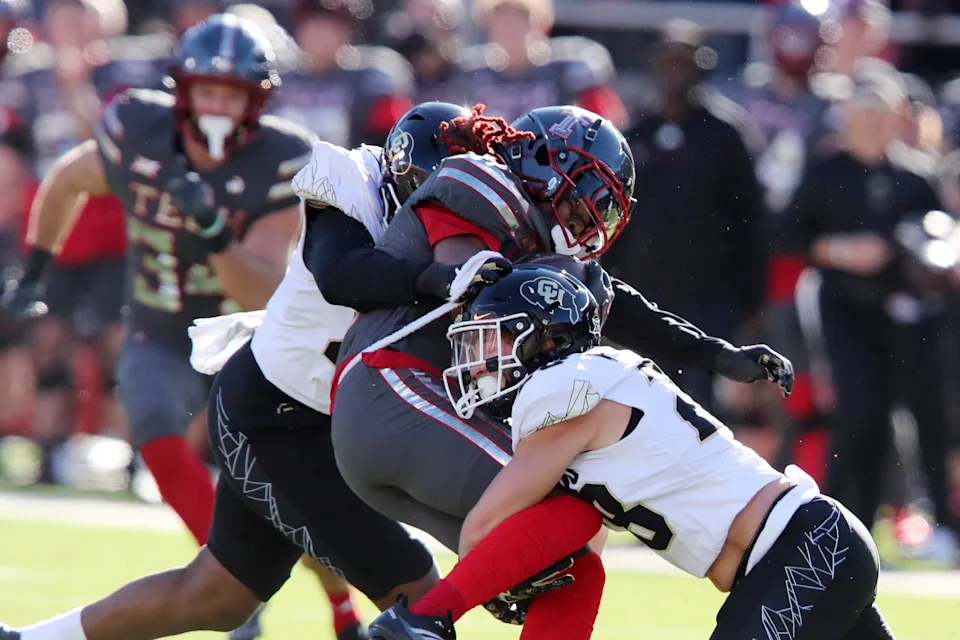 Nov 9, 2024; Lubbock, Texas, USA; Colorado Buffalos defensive safety Ben Finneseth (28) tackles Texas Tech Red Raiders wide receiver Jordan Brown (4) in the first half at Jones AT&T Stadium and Cody Campbell Field. Mandatory Credit: Michael C. Johnson-Imagn Images