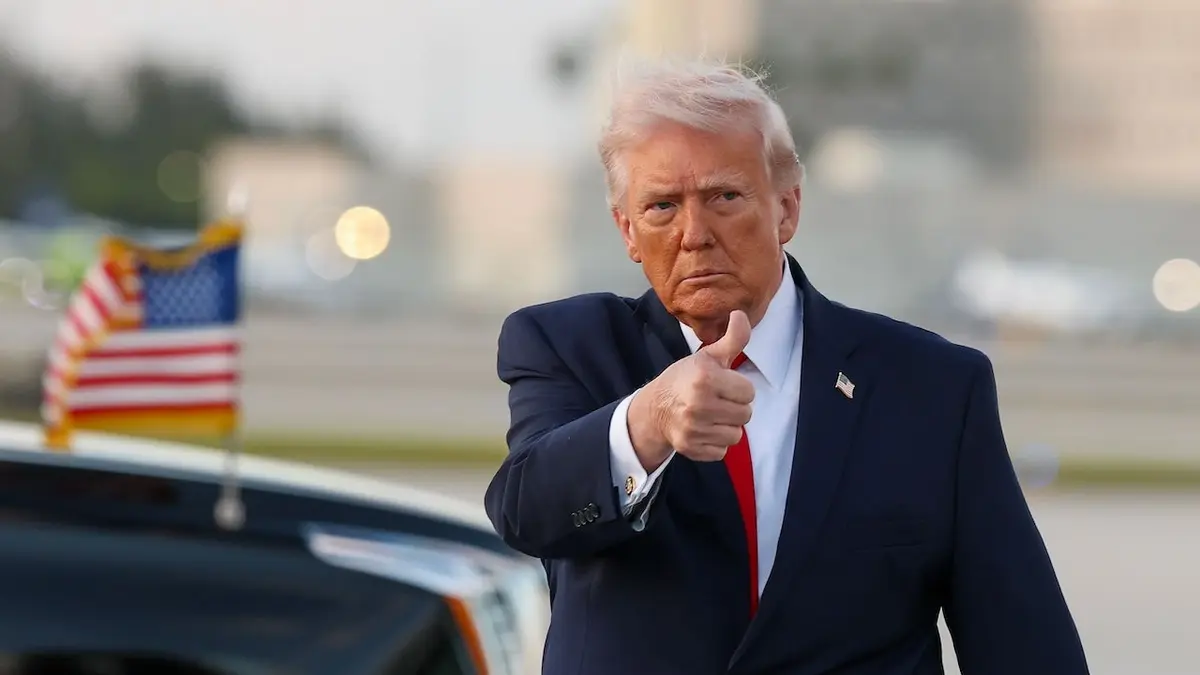 U.S. President Donald Trump waving to media after exiting Air Force One at Miami International Airport