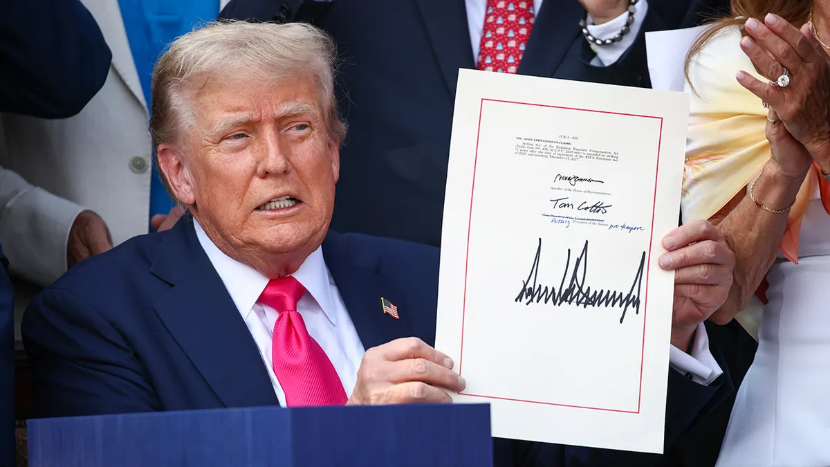 President Donald Trump signing the One, Big Beautiful Bill Act on the South Lawn of the White House with Republican lawmakers present