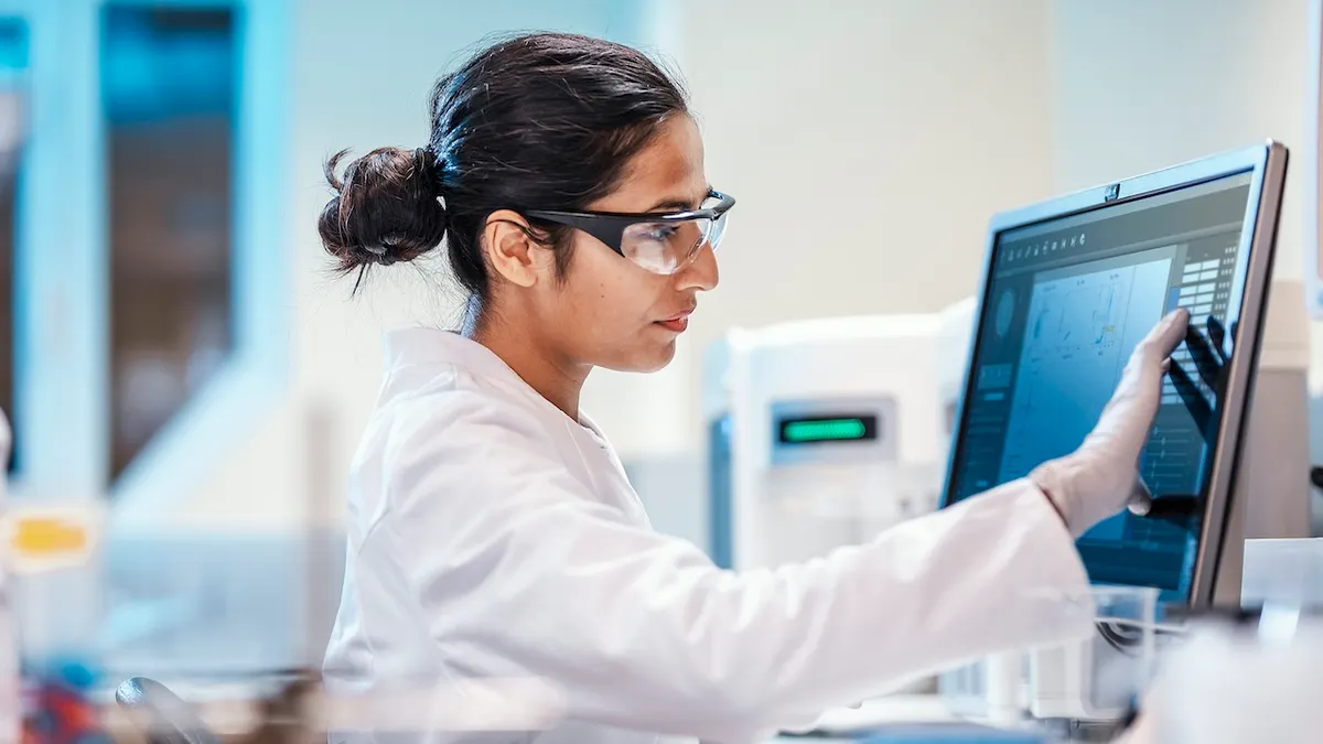 Female scientist using a computer in a laboratory setting