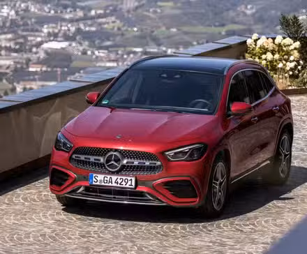 High-angle front shot of 2026 Mercedes-Benz GLA-Class in red being driven
